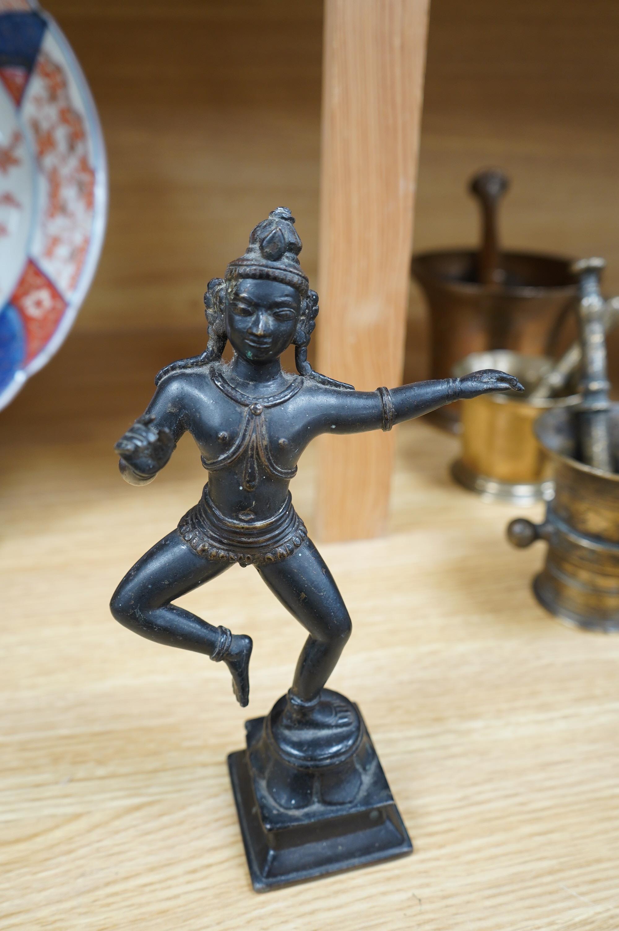 A Tibetan bronze dancing deity, 23cm high. Condition - fair